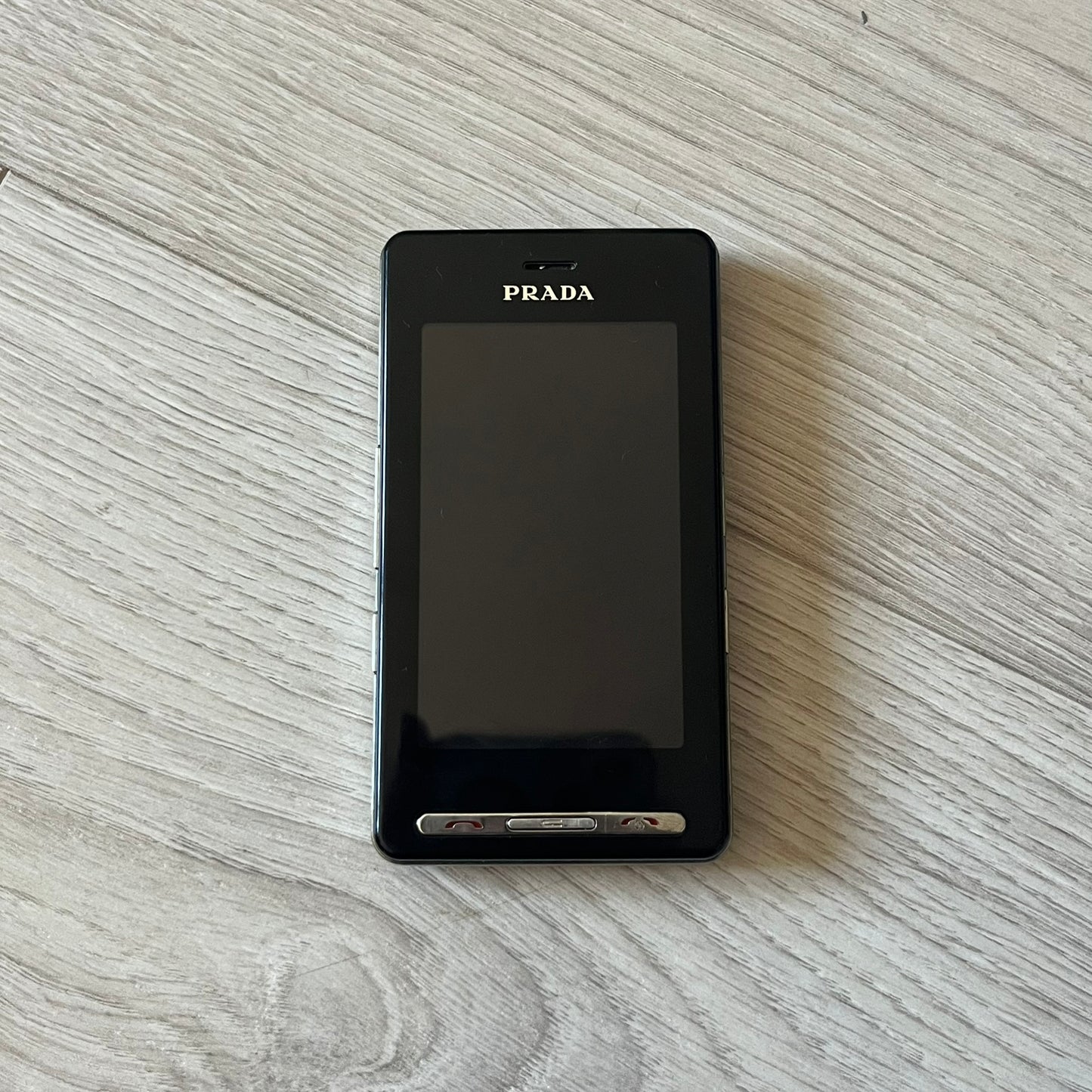 LG Prada KE850 touchscreen phone, the first of its kind with a capacitive display, designed in collaboration with Prada. Sleek black minimalist design, pre-loaded games, PDF and Office support, Bluetooth, and expandable memory. Comes complete with Prada box and leather etui - a collectible milestone in mobile fashion history.