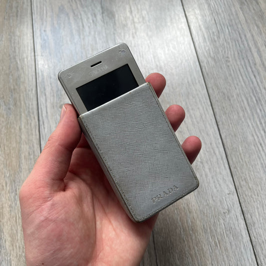 The LG Prada KE850, a groundbreaking collaboration between LG and Prada marked the world’s first capacitive touchscreen phone. Finished in silver and gray with minimalist Prada aesthetics, it features media playback, Bluetooth, and expandable memory. Sim locked.