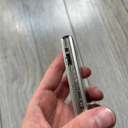 The LG Prada KE850, a groundbreaking collaboration between LG and Prada marked the world’s first capacitive touchscreen phone. Finished in silver and gray with minimalist Prada aesthetics, it features media playback, Bluetooth, and expandable memory. Sim locked.