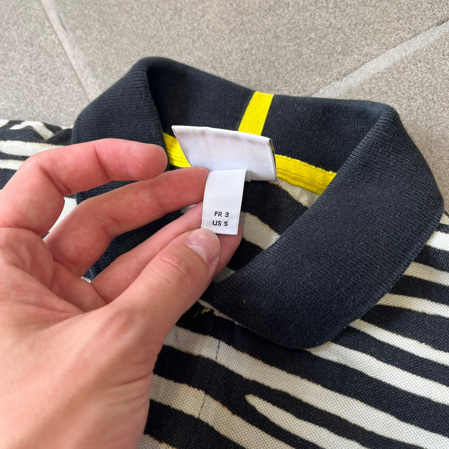 Lacoste x National Geographic AW20 Zebra Polo features an all-over white and black zebra print pattern across the fabric. The polo has black collar and sleeve hems, with a chest patch featuring the Lacoste crocodile logo in matching pattern colors.
