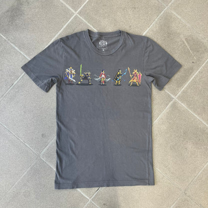 League of Legends 2013 Pixel Team Gray Tee is a gray T-shirt featuring a full five-champion team (Garen, Master Yi, Ahri, Ashe, and Kayle) rendered in pixel art style on the front. The upper back shows League main Logo. Licensed 2013 neck tag with the old Riot Games logo.