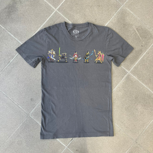 League of Legends 2013 Pixel Team Gray Tee is a gray T-shirt featuring a full five-champion team (Garen, Master Yi, Ahri, Ashe, and Kayle) rendered in pixel art style on the front. The upper back shows League main Logo. Licensed 2013 neck tag with the old Riot Games logo.