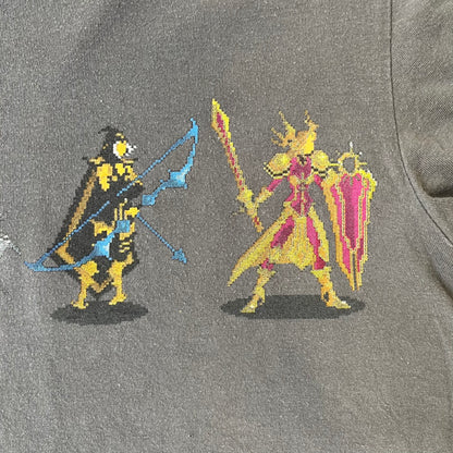 League of Legends 2013 Pixel Team Gray Tee is a gray T-shirt featuring a full five-champion team (Garen, Master Yi, Ahri, Ashe, and Kayle) rendered in pixel art style on the front. The upper back shows League main Logo. Licensed 2013 neck tag with the old Riot Games logo.