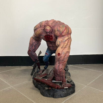 Left 4 Dead 2: Tank 2011 Exclusive Gaming Heads Statue is a limited edition poly-stone collectible based on the Tank character from Left 4 Dead 2. The statue is hand finished and hand painted, depicting the Tank smashing through a reinforced door with glow-in-the-dark painted eyes. It measures approximately 15 inches tall including the base and was limited to 300 pieces worldwide. This exclusive version comes with additional to scale Pump Shotgun that wasn't added in the standard edition. This piece is numb