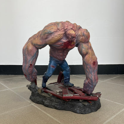 Left 4 Dead 2 Tank 2011 Gaming Heads Statue is a limited edition poly-stone collectible based on the Tank character from Left 4 Dead 2. The statue is hand finished and hand painted, depicting the Tank smashing through a reinforced door with glow-in-the-dark painted eyes. It measures approximately 15 inches tall including the base and was limited to 750 pieces worldwide. This piece is number 224 and comes with the original shipping box, styrofoam packaging, colored box, and identification/validation card.
