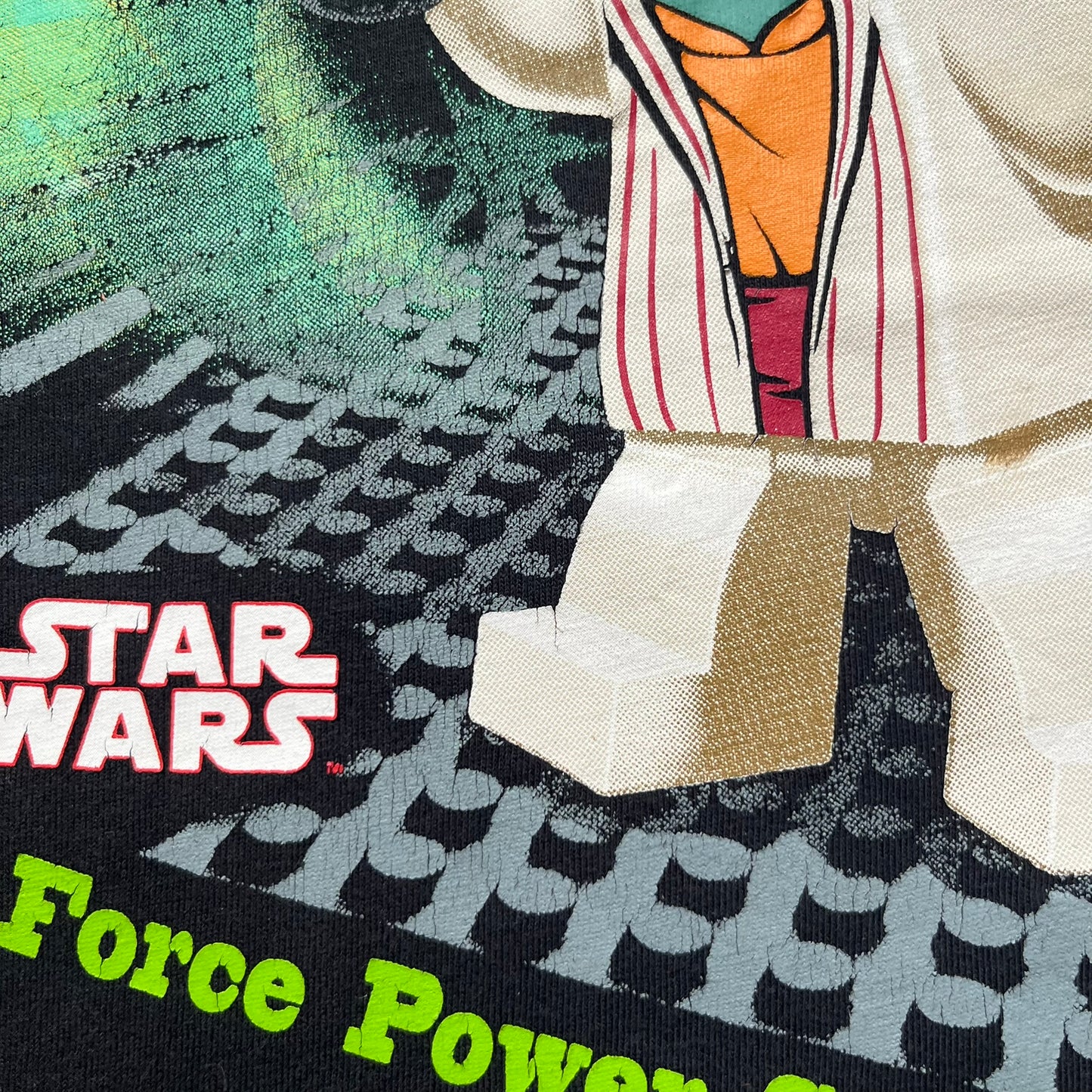 LEGO Yoda “Jedi Master” 2009 Tee is a black short-sleeve t-shirt featuring a front graphic of Yoda swinging a green lightsaber. Above the graphic is “Yoda Jedi Master” text in green, with “Force Power Strength” printed underneath. The tee includes a LEGO Star Wars 2009 neck tag.