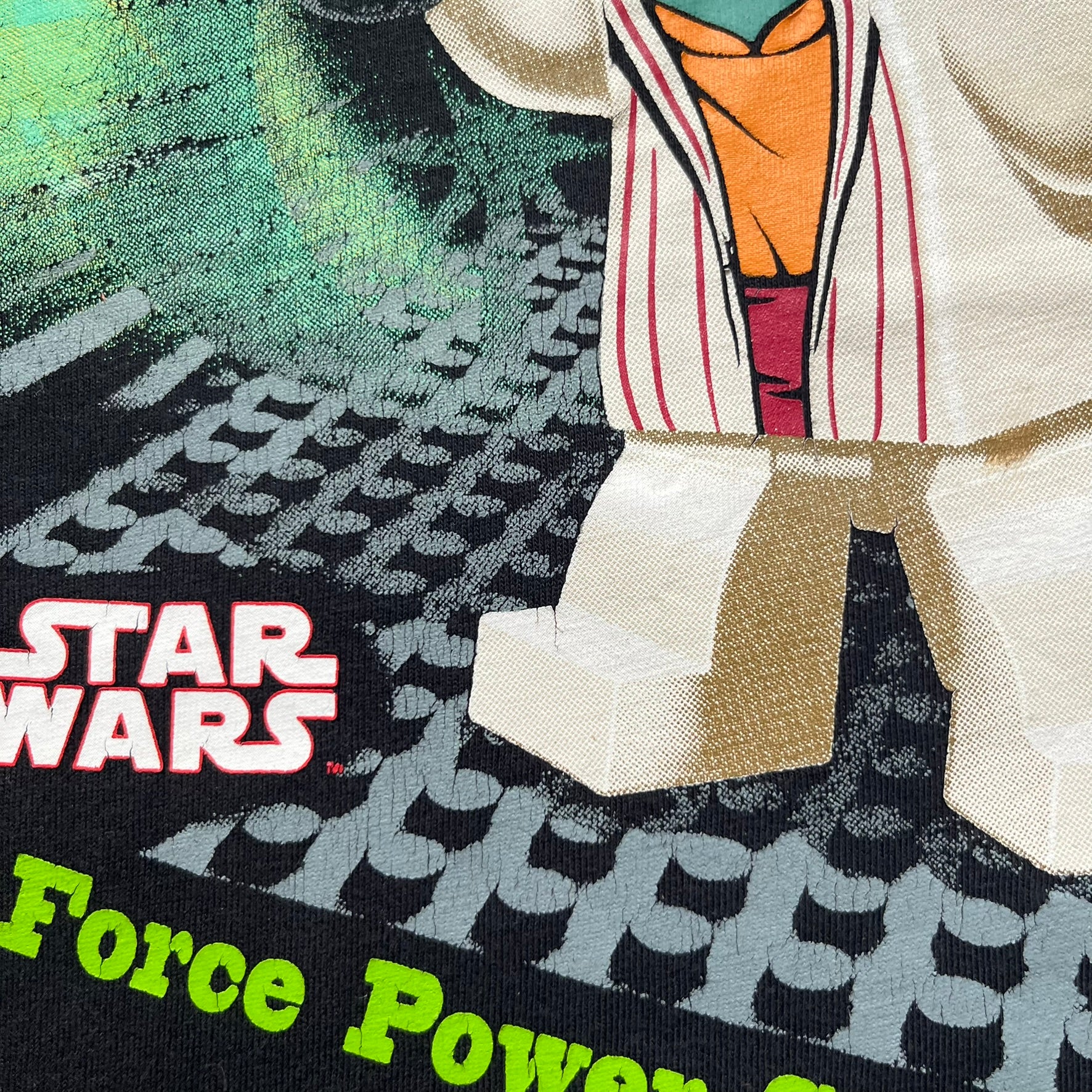 LEGO Yoda “Jedi Master” 2009 Tee is a black short-sleeve t-shirt featuring a front graphic of Yoda swinging a green lightsaber. Above the graphic is “Yoda Jedi Master” text in green, with “Force Power Strength” printed underneath. The tee includes a LEGO Star Wars 2009 neck tag.