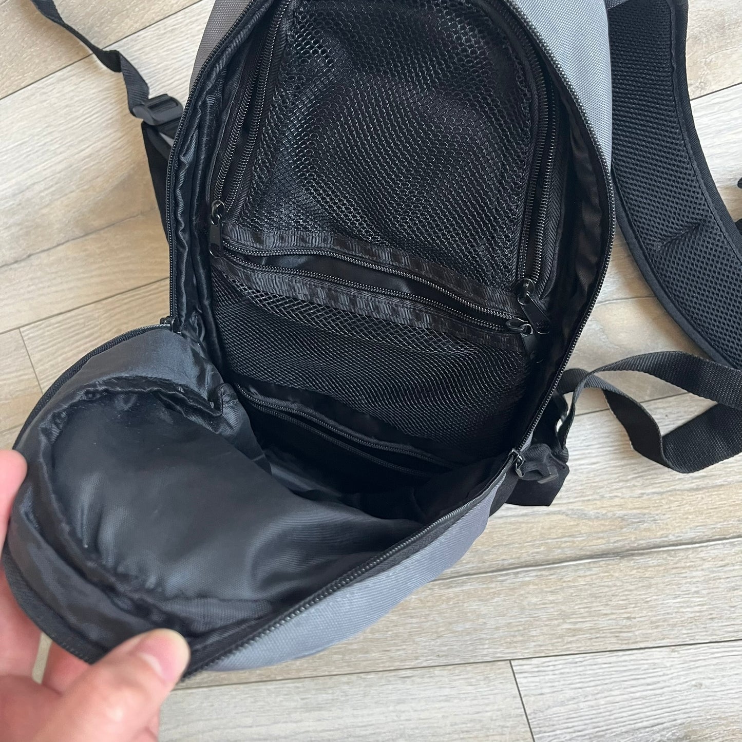 Lego Bionicle 2000s Matoran Alphabet Backpack is a backpack featuring a front design spelling “Bionicle” using the Matoran alphabet. The bag includes two front exterior pockets, a main compartment with three internal pockets, and a top media port for headphones. Additional details include padded and vented back panel, adjustable shoulder straps with chest connector and waist strap, top handle, and elastic cross straps on the front for extra storage.
