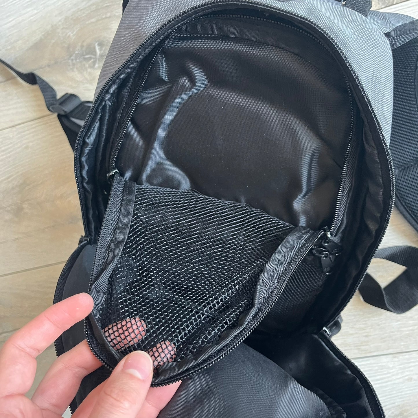 Lego Bionicle 2000s Matoran Alphabet Backpack is a backpack featuring a front design spelling “Bionicle” using the Matoran alphabet. The bag includes two front exterior pockets, a main compartment with three internal pockets, and a top media port for headphones. Additional details include padded and vented back panel, adjustable shoulder straps with chest connector and waist strap, top handle, and elastic cross straps on the front for extra storage.

