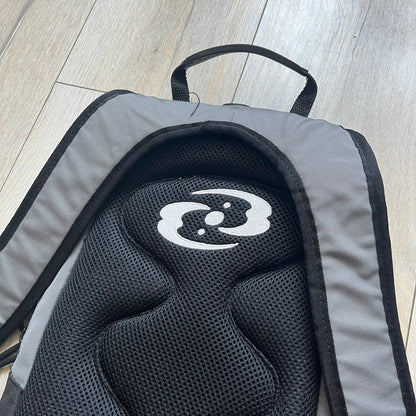Lego Bionicle 2000s Matoran Alphabet Backpack is a backpack featuring a front design spelling “Bionicle” using the Matoran alphabet. The bag includes two front exterior pockets, a main compartment with three internal pockets, and a top media port for headphones. Additional details include padded and vented back panel, adjustable shoulder straps with chest connector and waist strap, top handle, and elastic cross straps on the front for extra storage.
