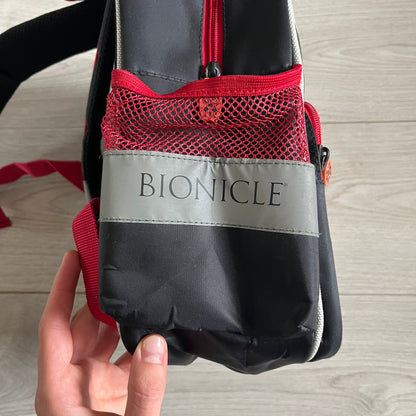 Lego Bionicle 2010 Glatorian Gresh Backpack made by Class Investment in 2010, featuring a front pocket with an embroidered Glatorian Ackar figure and text. The top pocket includes both Bionicle and LEGO logos, along with custom rubber zipper pulls. Finished with two side bottle pockets and additional Bionicle logo details, making it a great rare collectible for fans of the series.