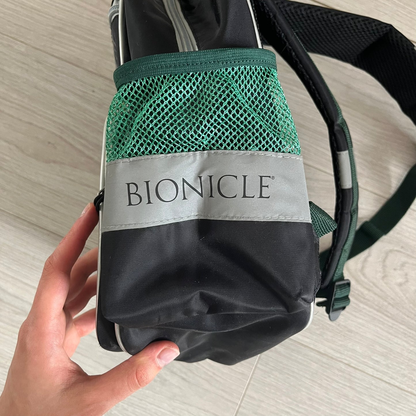 Lego Bionicle 2010 Glatorian Gresh Backpack made by Class Investment in 2010, featuring a front pocket with an embroidered Glatorian Gresh figure and text. The top pocket includes both Bionicle and LEGO logos, along with custom rubber zipper pulls. Finished with two side bottle pockets and additional Bionicle logo details, making it a great rare collectible for fans of the series.
