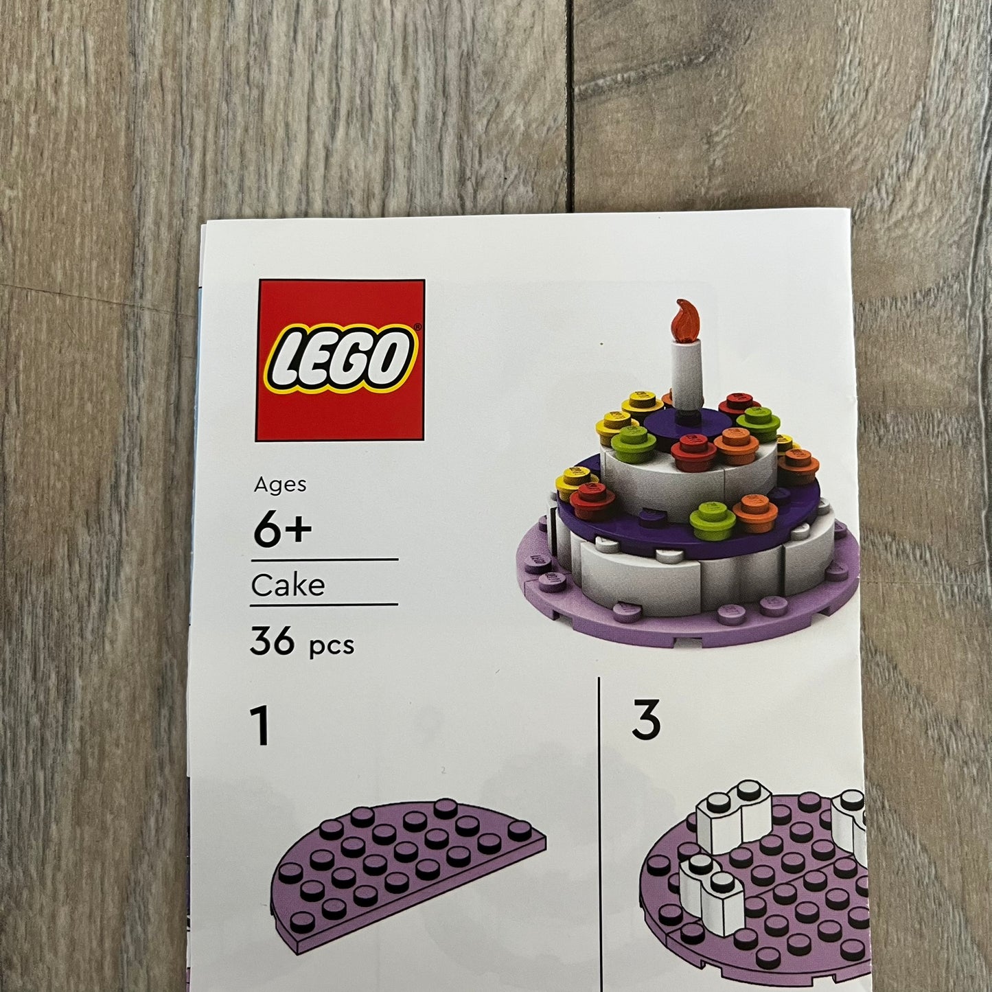 LEGO Cake Make and Take Build is a limited promotional LEGO set distributed as an exclusive “make & take” event and not available for retail purchase. The model features a small white and purple cake-style build with multicolor dot detailing and a single candle element on top.