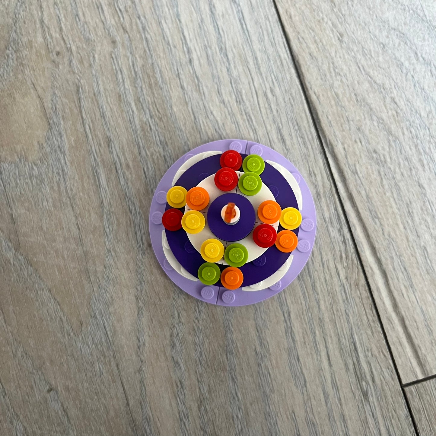 LEGO Cake Make and Take Build is a limited promotional LEGO set distributed as an exclusive “make & take” event and not available for retail purchase. The model features a small white and purple cake-style build with multicolor dot detailing and a single candle element on top.