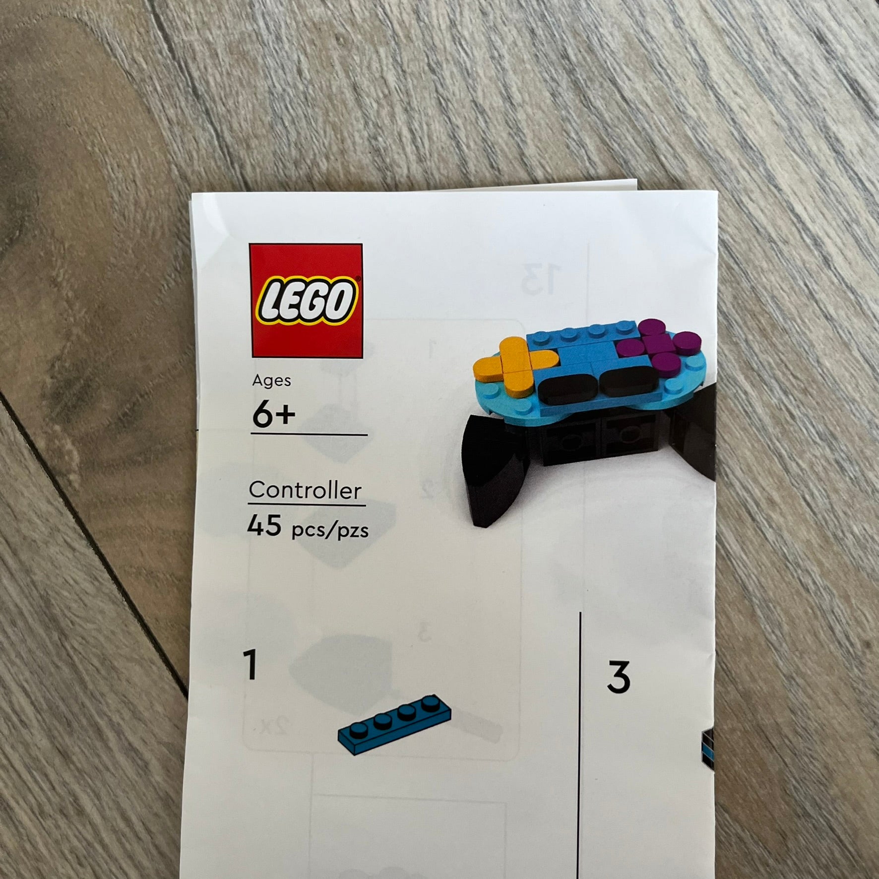 LEGO Controller Make and Take Build is a limited promotional LEGO set distributed as an exclusive “make & take” event and not available for retail purchase. The model features a small controller build in blue and black, with yellow and pink button elements.