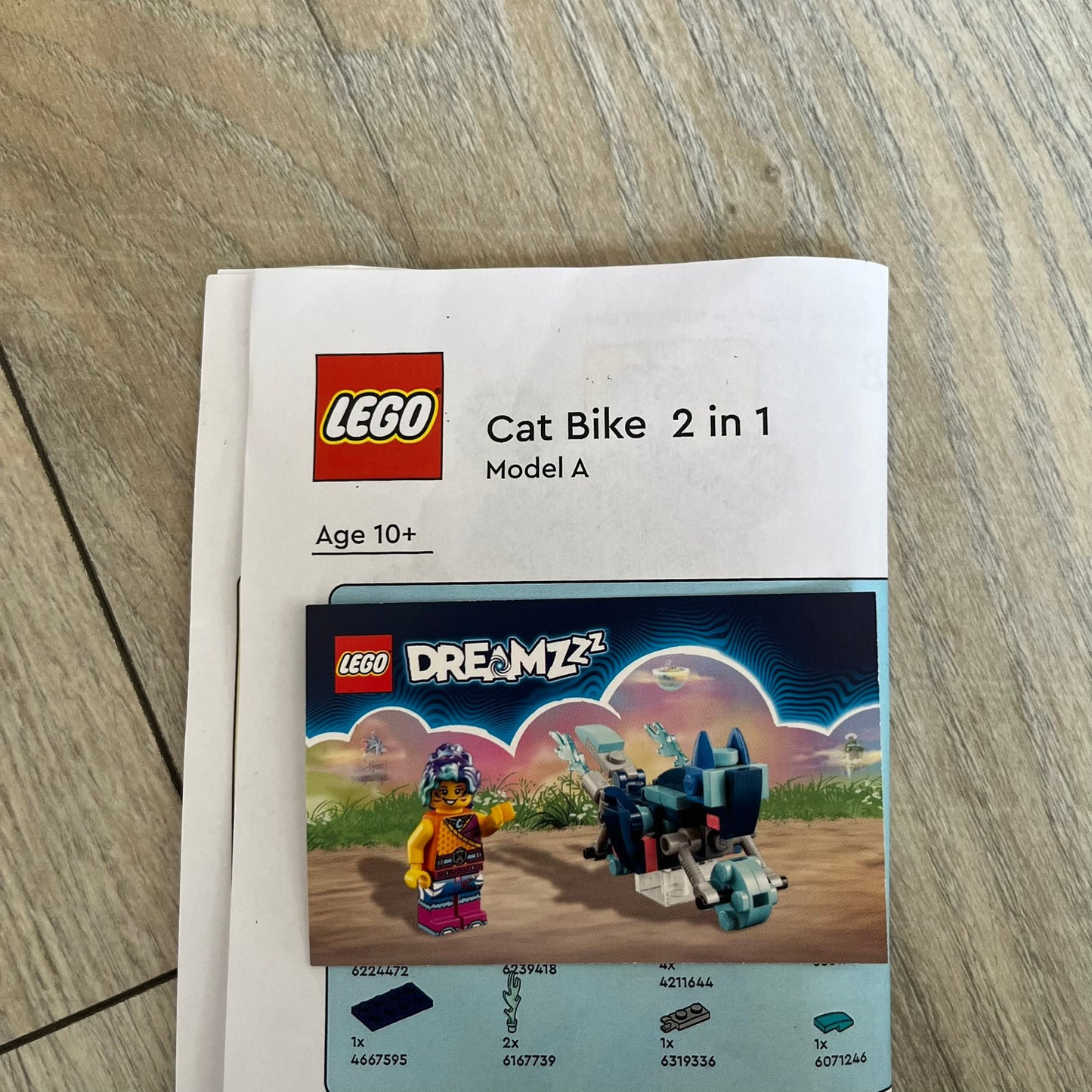 LEGO DREAMZzz Cat Bike 2-in-1 Make and Take Build is a limited promotional LEGO set distributed as an exclusive “make & take” event and not available for retail purchase. The model features a blue motorcycle with flame elements and a rider character wearing a blue vest. The build is designed as a 2-in-1 concept, allowing transformation into an alternate vehicle configuration.