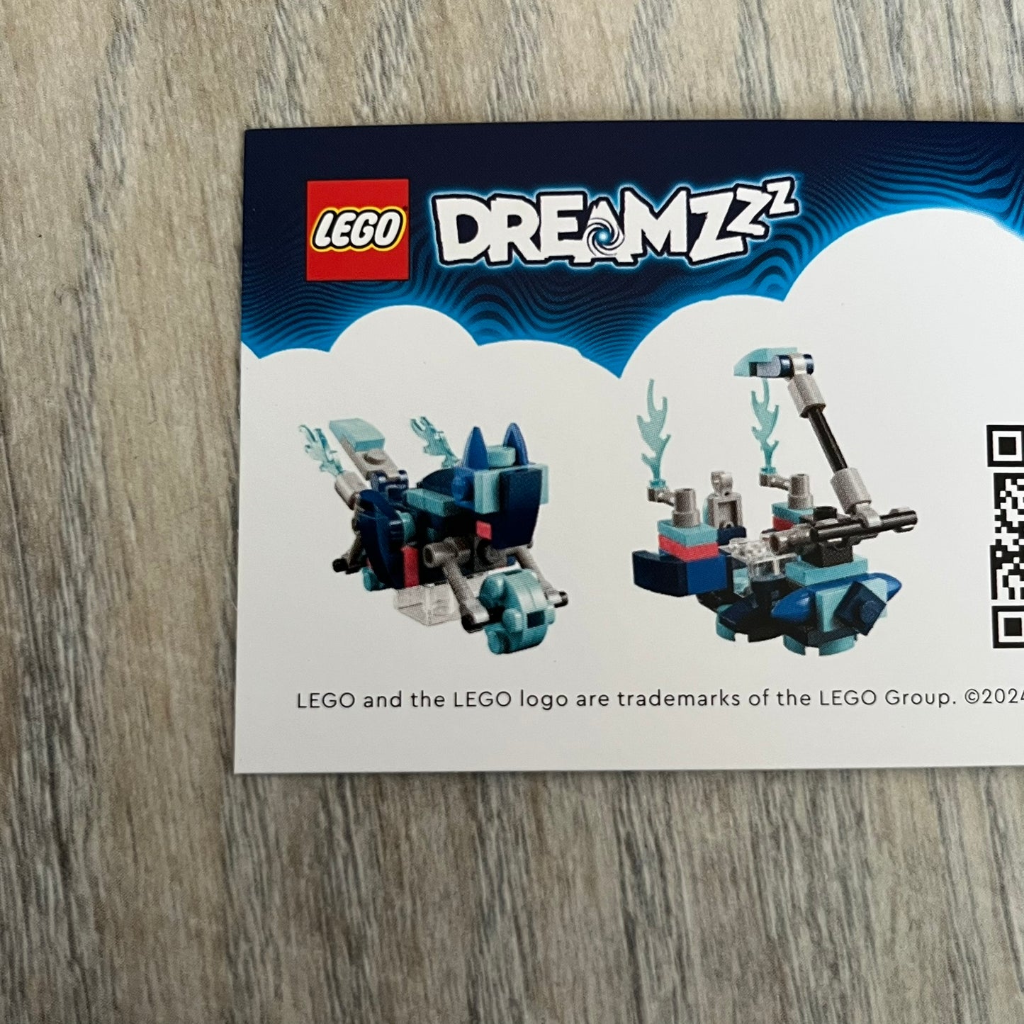 LEGO DREAMZzz Cat Bike 2-in-1 Make and Take Build is a limited promotional LEGO set distributed as an exclusive “make & take” event and not available for retail purchase. The model features a blue motorcycle with flame elements and a rider character wearing a blue vest. The build is designed as a 2-in-1 concept, allowing transformation into an alternate vehicle configuration.