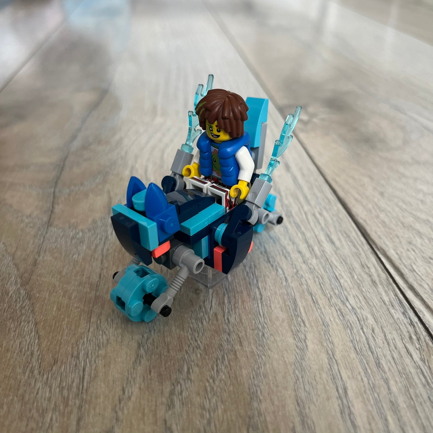 LEGO DREAMZzz Cat Bike 2-in-1 Make and Take Build is a limited promotional LEGO set distributed as an exclusive “make & take” event and not available for retail purchase. The model features a blue motorcycle with flame elements and a rider character wearing a blue vest. The build is designed as a 2-in-1 concept, allowing transformation into an alternate vehicle configuration.