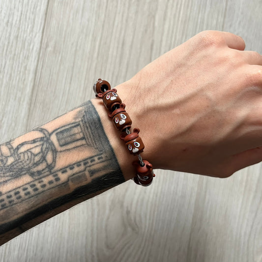Lego Graduation Brick Bracelet featuring ten brown Lego bear heads from Kanye West’s Graduation era, set on a thin silver bracelet. The heads are standard Lego size and the piece comes in a custom-designed display box. Made by TheCanvasDon.