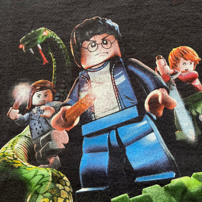 Close-up of a LEGO figure with a snake and other characters in the background