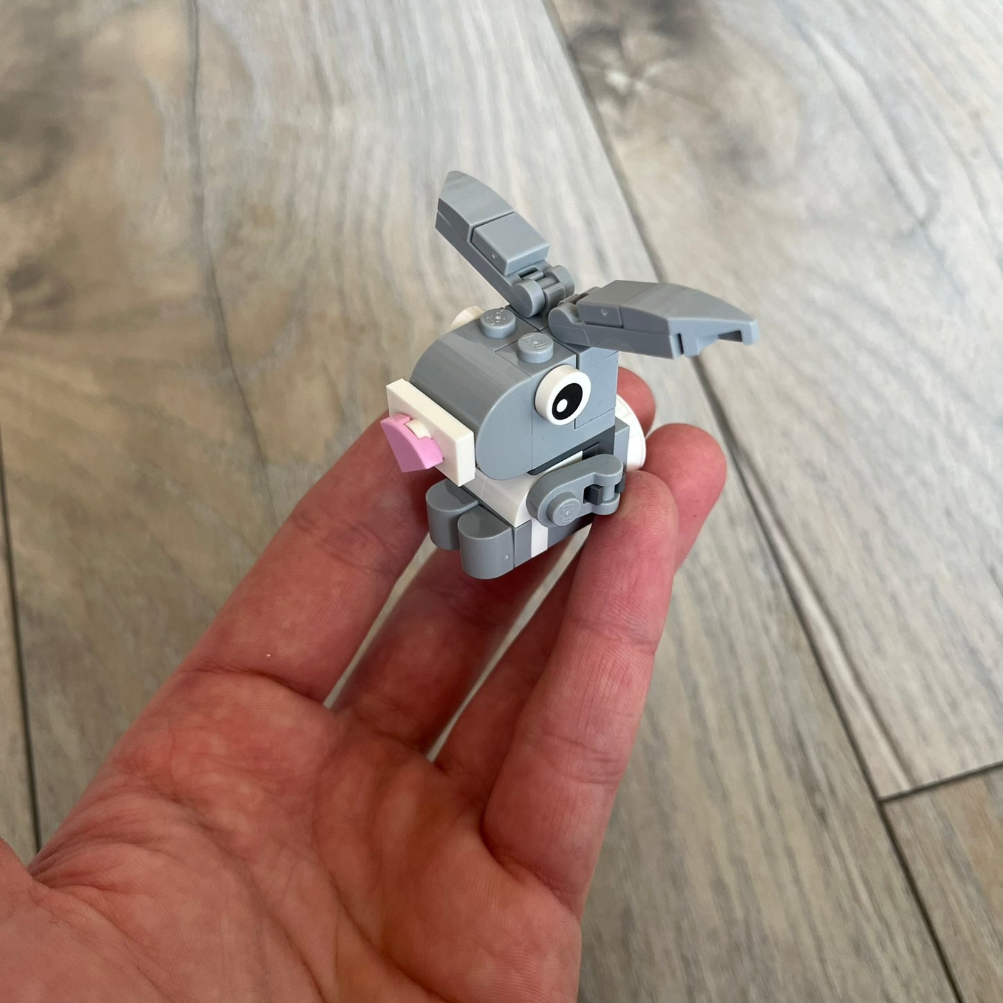 LEGO Rabbit Make and Take Build is a limited promotional LEGO set distributed as an exclusive “make & take” event and not available for retail purchase. The model features a small grey and white rabbit with movable ears and articulated front limbs.
