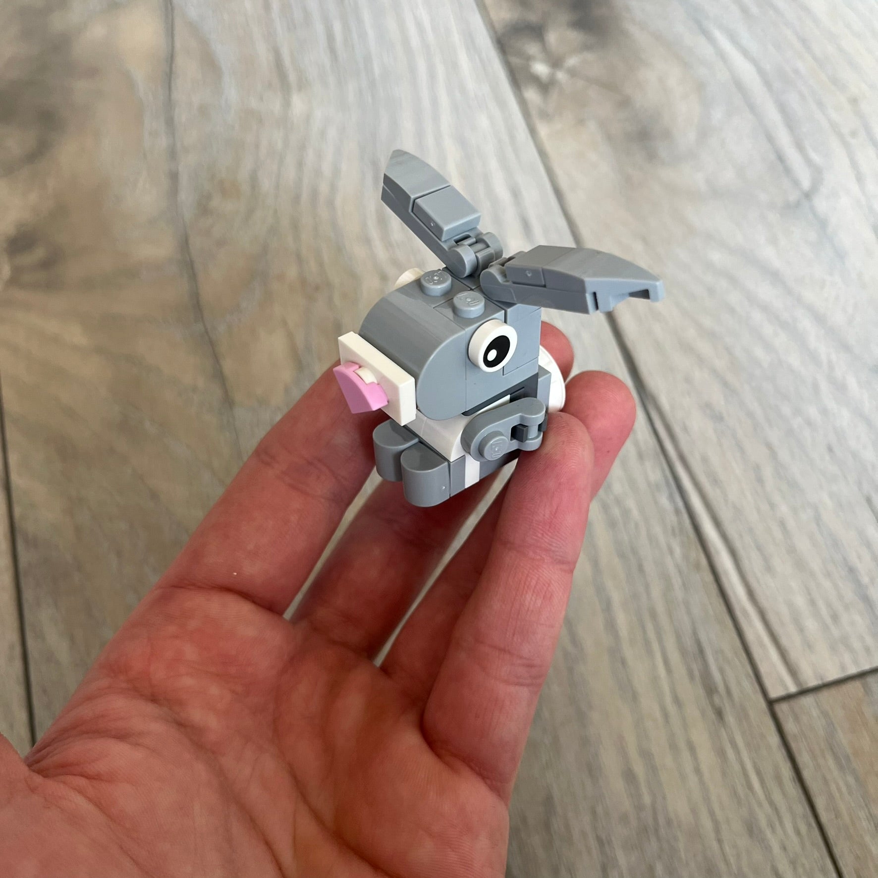LEGO Rabbit Make and Take Build is a limited promotional LEGO set distributed as an exclusive “make & take” event and not available for retail purchase. The model features a small grey and white rabbit with movable ears and articulated front limbs.
