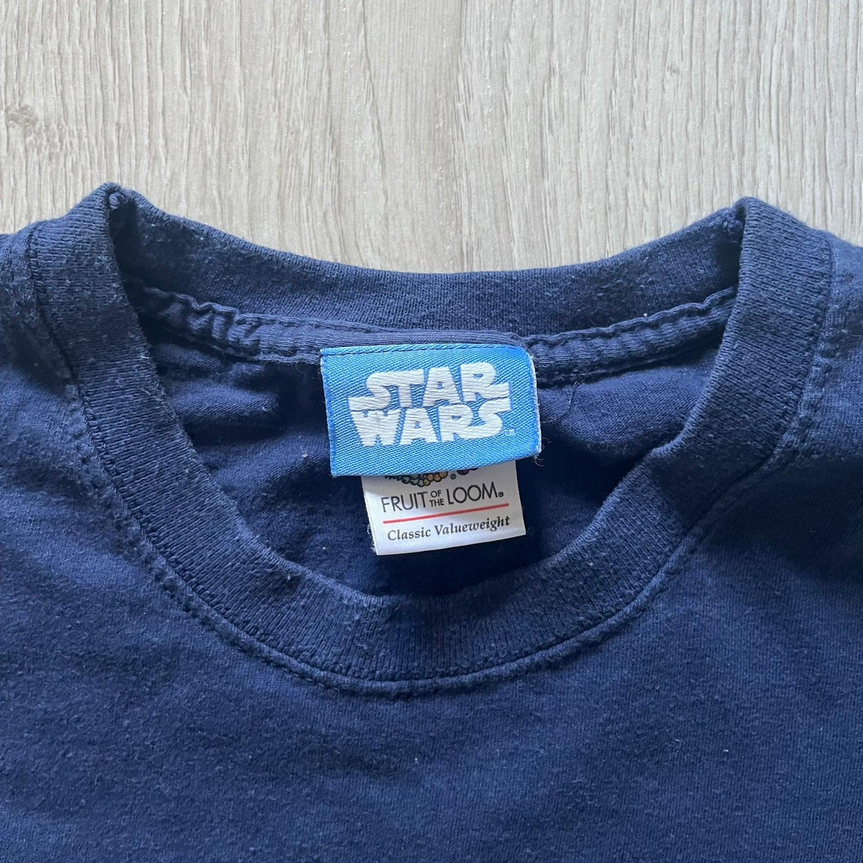 Vintage 2007 Lego Star Wars tee featuring Luke Skywalker with a lightsaber and the quote “I am a Jedi like my father before me.” Small Lego Star Wars logo sits underneath the graphic. Printed on a classic navy Fruit of the Loom blank perfect for collectors and SW fans.
