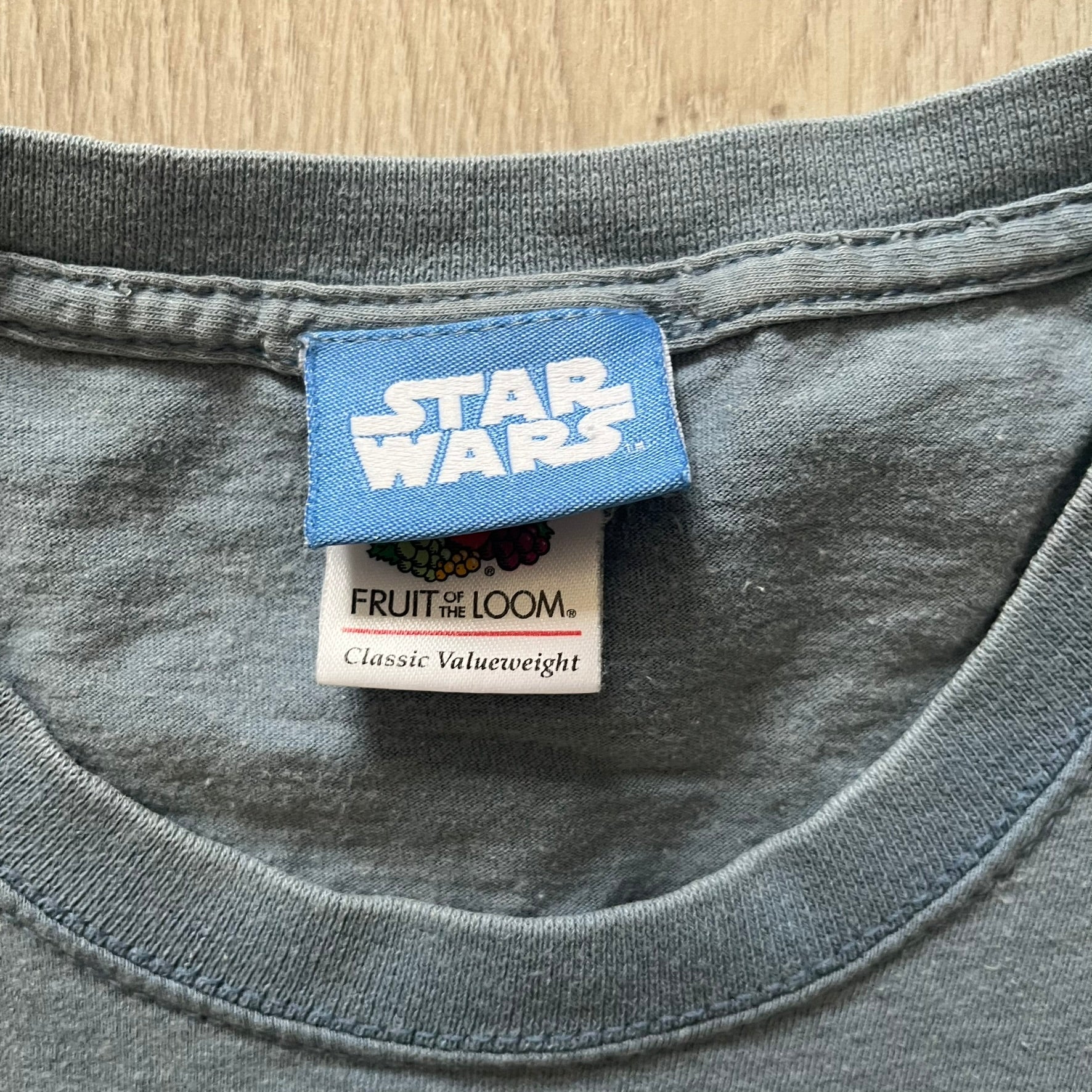 Vintage Lego Star Wars Jedi tee from 2008 in light blue. Showcases a clean white Lego Skywalker graphic with lightsaber and bold “Jedi” lettering underneath. Officially licensed and made on a soft Fruit of the Loom blank.