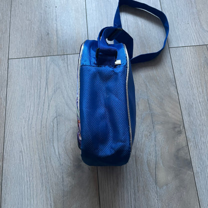 Lego Star Wars III: The Clone Wars Shoulder Bag is a blue shoulder bag featuring a raised 3D front graphic panel (not printed) with Lego Star Wars artwork. The design shows Obi-Wan Kenobi, Anakin Skywalker, and Yoda with lightsabers on a battlefield scene, with clone troopers, Ahsoka Tano, and General Grievous in the background.