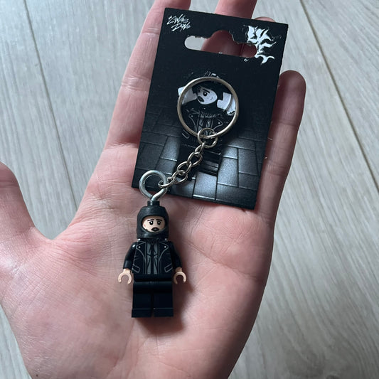 Lego Yeat 'Brick Lyfe' keychain featuring a custom Lego figure of Yeat with his black jacket and a black balaclava. The figure is attached to a Lego-style recreation of the 2022 Lyfe EP cover, reimagined in brick graphics. A playful and creative collectible that merges music culture with fan-made Lego artistry, made by TheCanvasDon.
