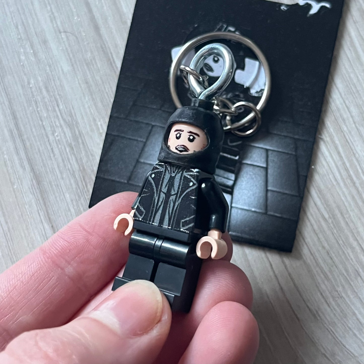 Lego Yeat 'Brick Lyfe' keychain featuring a custom Lego figure of Yeat with his black jacket and a black balaclava. The figure is attached to a Lego-style recreation of the 2022 Lyfe EP cover, reimagined in brick graphics. A playful and creative collectible that merges music culture with fan-made Lego artistry, made by TheCanvasDon.