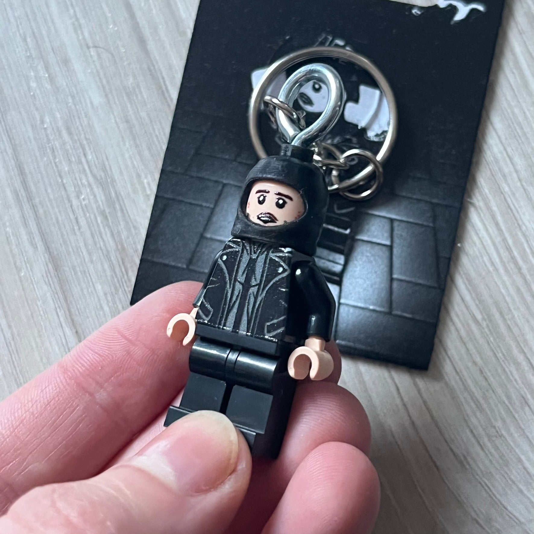 Lego Yeat 'Brick Lyfe' keychain featuring a custom Lego figure of Yeat with his black jacket and a black balaclava. The figure is attached to a Lego-style recreation of the 2022 Lyfe EP cover, reimagined in brick graphics. A playful and creative collectible that merges music culture with fan-made Lego artistry, made by TheCanvasDon.