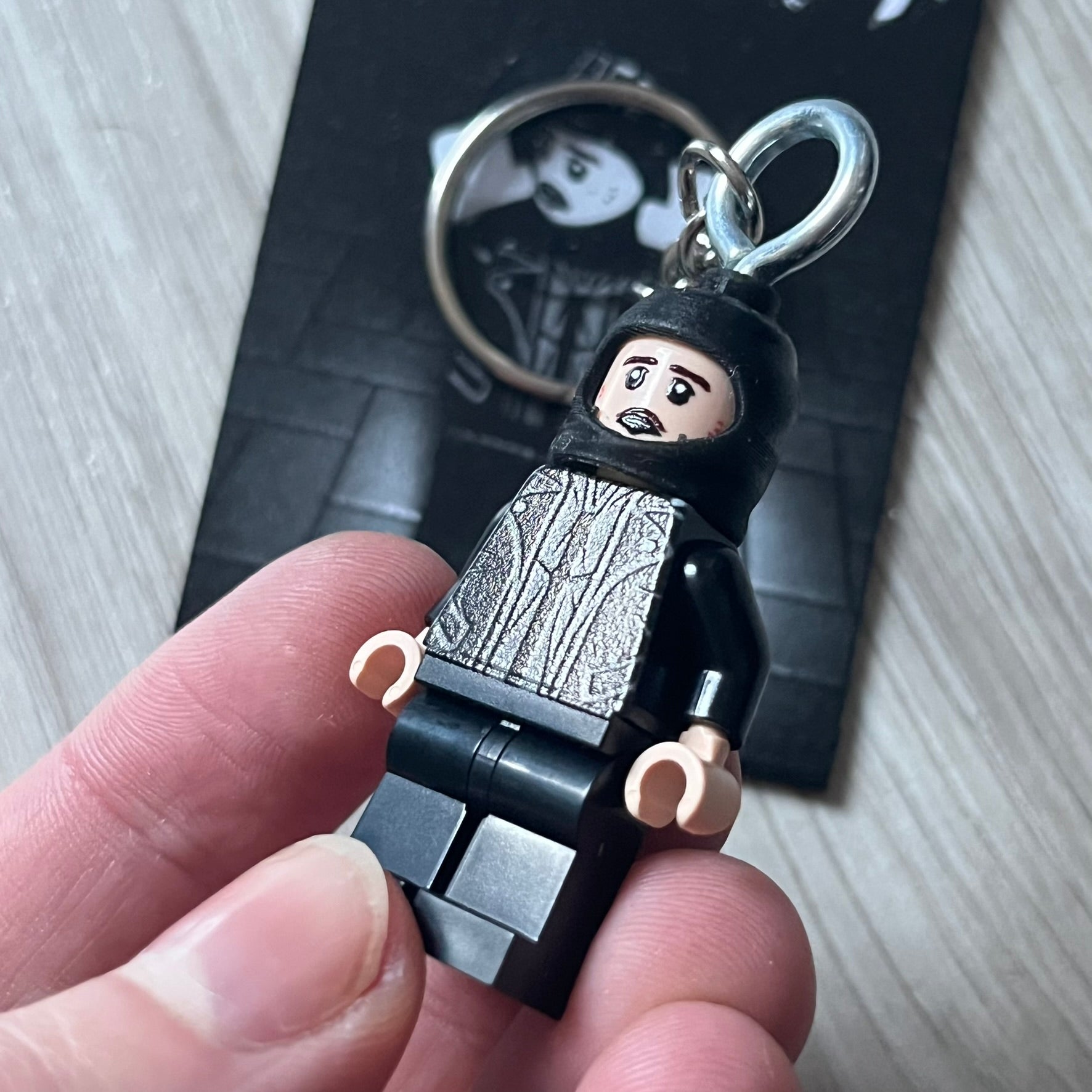 Lego Yeat 'Brick Lyfe' keychain featuring a custom Lego figure of Yeat with his black jacket and a black balaclava. The figure is attached to a Lego-style recreation of the 2022 Lyfe EP cover, reimagined in brick graphics. A playful and creative collectible that merges music culture with fan-made Lego artistry, made by TheCanvasDon.