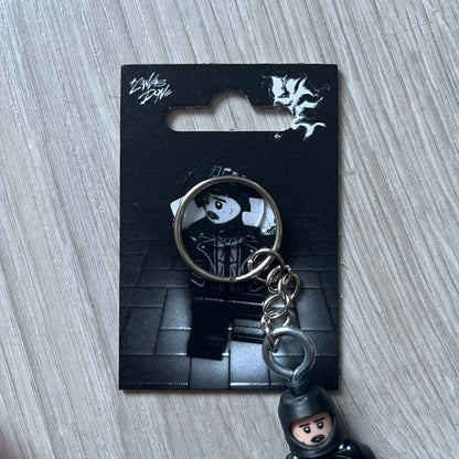 Lego Yeat 'Brick Lyfe' keychain featuring a custom Lego figure of Yeat with his black jacket and a black balaclava. The figure is attached to a Lego-style recreation of the 2022 Lyfe EP cover, reimagined in brick graphics. A playful and creative collectible that merges music culture with fan-made Lego artistry, made by TheCanvasDon.