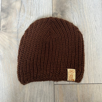 LittleBigPlanet 2009 Europe Exclusive Sackboy Beanie is an officially licensed brown knit beanie made from 100% acrylic. The design is styled after Sackboy and features a beige front tag with an orange Sackboy figure, LittleBigPlanet logo, and SCEE 2009 licensing. This item was released exclusively in the European region. Super rare and rarely seen for sale.