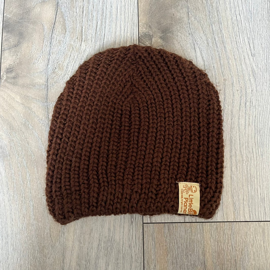 LittleBigPlanet 2009 Europe Exclusive Sackboy Beanie is an officially licensed brown knit beanie made from 100% acrylic. The design is styled after Sackboy and features a beige front tag with an orange Sackboy figure, LittleBigPlanet logo, and SCEE 2009 licensing. This item was released exclusively in the European region. Super rare and rarely seen for sale.