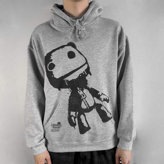Ultra-rare Little Big Planet hoodie from 2010, made on a Gildan Heavy Blend. Showcases a graffiti like print with Sackboy and logo LBP branding on the pocket with Sony/SCEE licensing. This piece is nearly impossible to find today, making it a standout collectible for fans.