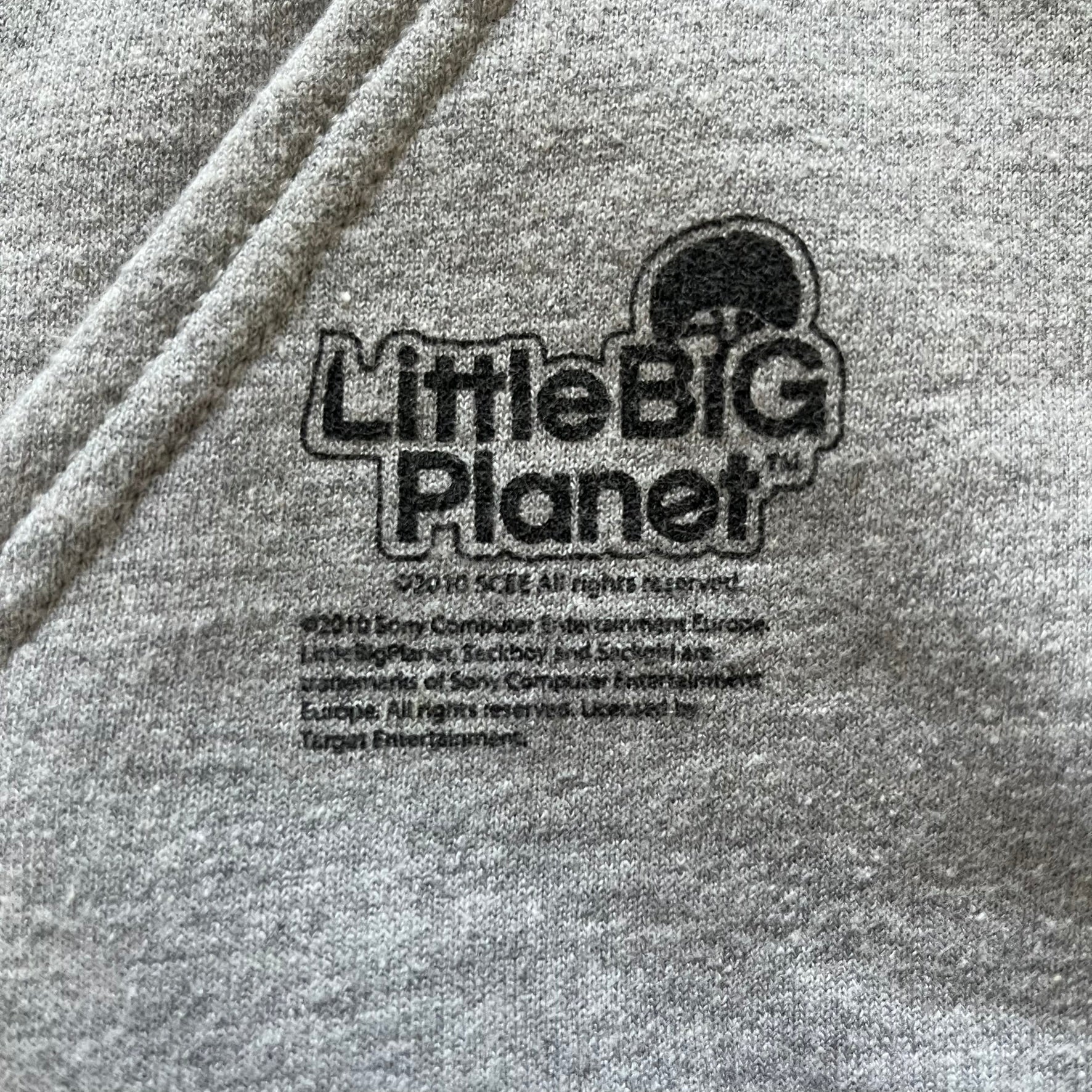 Ultra-rare Little Big Planet hoodie from 2010, made on a Gildan Heavy Blend. Showcases a graffiti like print with Sackboy and logo LBP branding on the pocket with Sony/SCEE licensing. This piece is nearly impossible to find today, making it a standout collectible for fans.