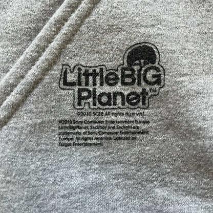 Ultra-rare Little Big Planet hoodie from 2010, made on a Gildan Heavy Blend. Showcases a graffiti like print with Sackboy and logo LBP branding on the pocket with Sony/SCEE licensing. This piece is nearly impossible to find today, making it a standout collectible for fans.