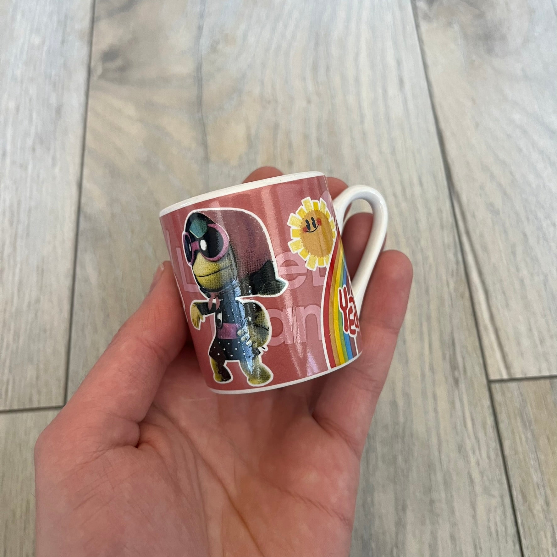 LittleBigPlanet 2011 Collectable Mini Mugs + Saucers Set is a 4-piece espresso set featuring characters from the LittleBigPlanet series, including Sackboy, Marvin the Disco Dancer, Gloria, and Yuri Army Sackboy. Each mini mug includes a wraparound character graphic with the LittleBigPlanet logo and comes with a matching saucer printed on the top. The set is officially licensed by Sony Computer Entertainment, includes a display box, and carries SCEE 2011 licensing on the base of the mugs and saucers.