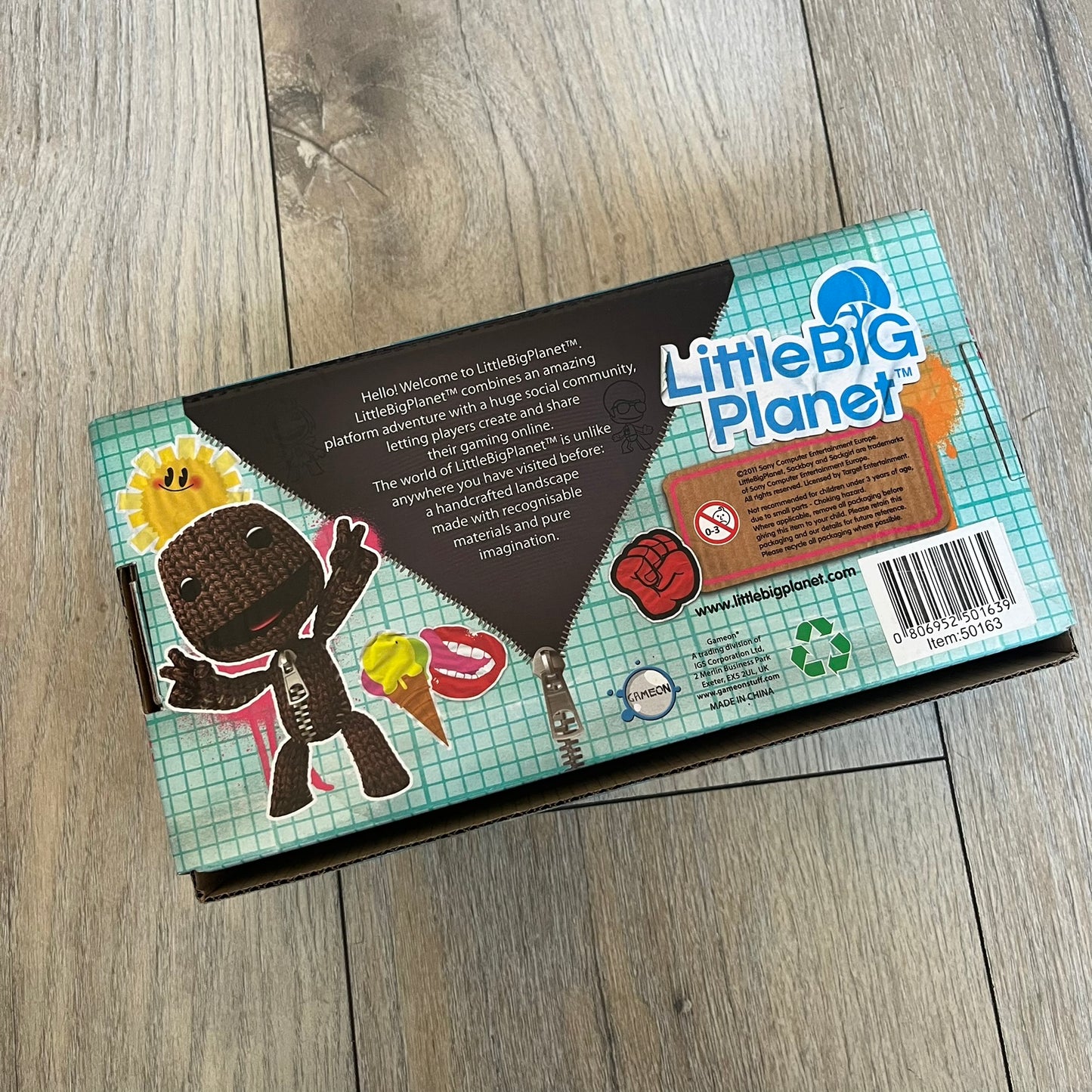 LittleBigPlanet 2011 Collectable Mini Mugs + Saucers Set is a 4-piece espresso set featuring characters from the LittleBigPlanet series, including Sackboy, Marvin the Disco Dancer, Gloria, and Yuri Army Sackboy. Each mini mug includes a wraparound character graphic with the LittleBigPlanet logo and comes with a matching saucer printed on the top. The set is officially licensed by Sony Computer Entertainment, includes a display box, and carries SCEE 2011 licensing on the base of the mugs and saucers.