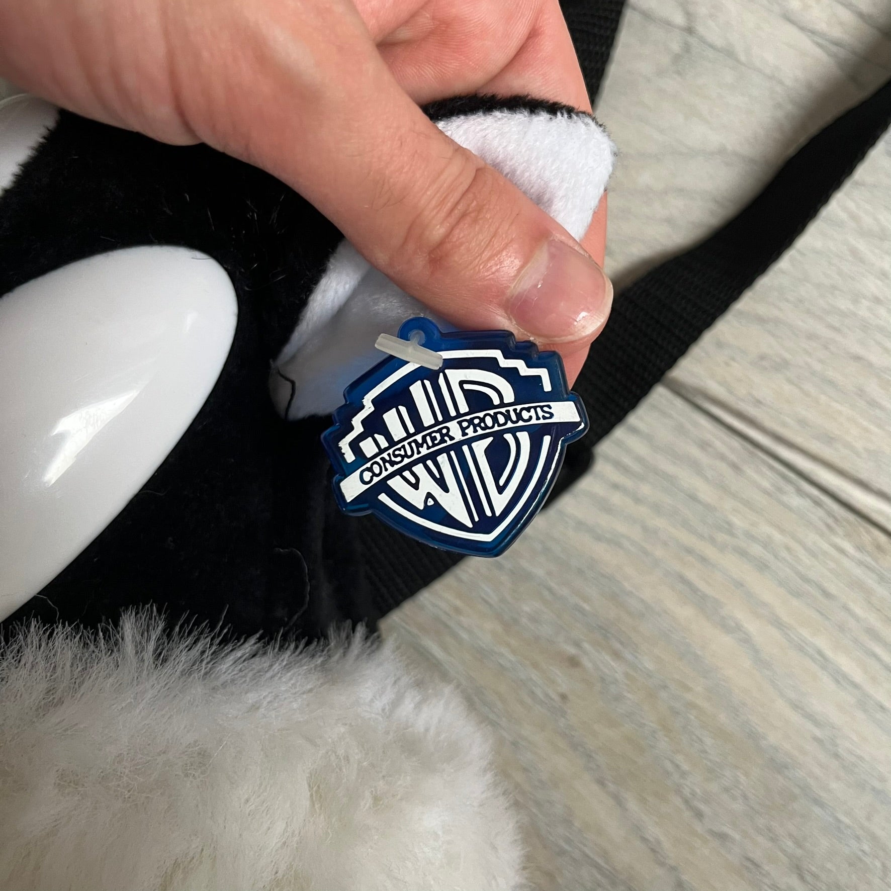 Looney Tunes 1996 Sylvester Head Backpack is a backpack shaped like Sylvester’s head. It features a furry exterior, white plastic eyes, a red nose, and detailed character features throughout. The backpack includes black shoulder straps, a blue plastic Warner Bros. tag, and a 1996 licensing tag.
