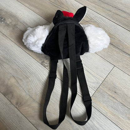 Looney Tunes 1996 Sylvester Head Backpack is a backpack shaped like Sylvester’s head. It features a furry exterior, white plastic eyes, a red nose, and detailed character features throughout. The backpack includes black shoulder straps, a blue plastic Warner Bros. tag, and a 1996 licensing tag.