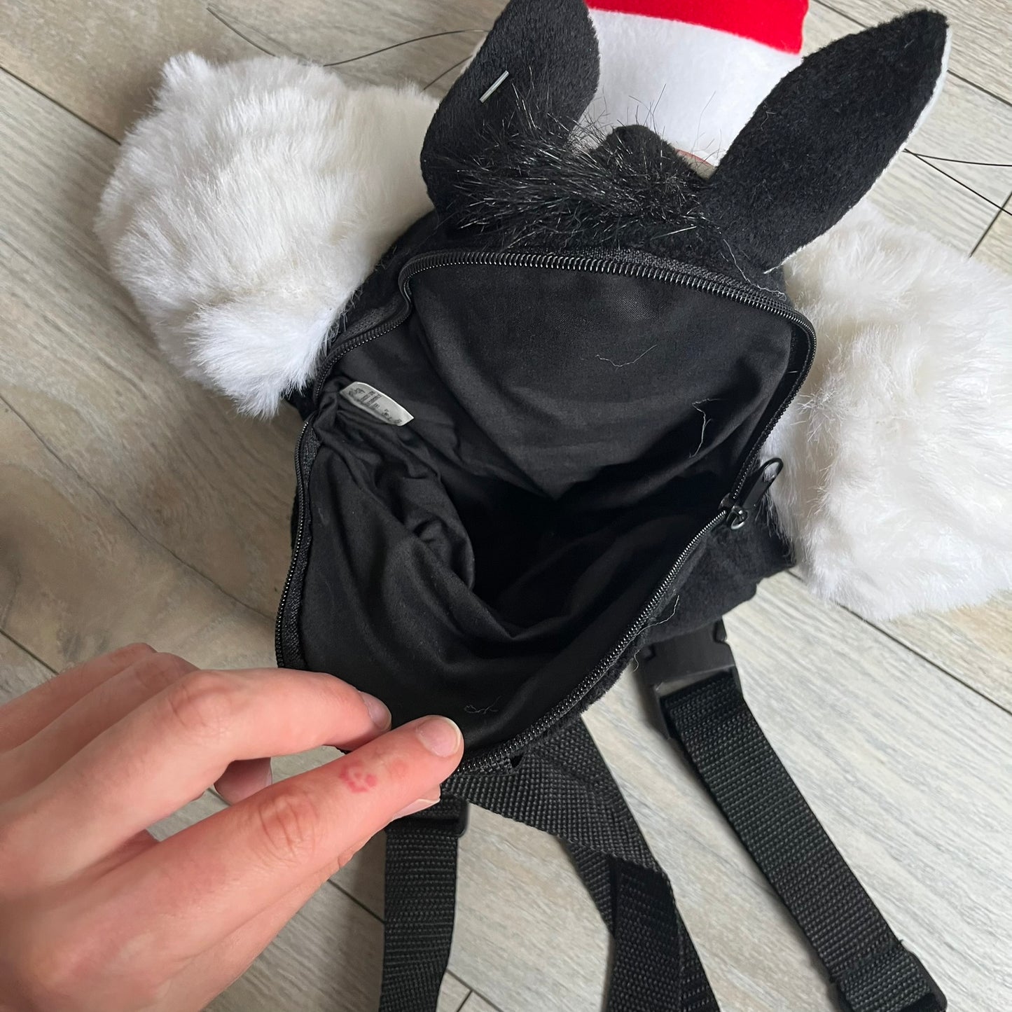 Looney Tunes 1996 Sylvester Head Backpack is a backpack shaped like Sylvester’s head. It features a furry exterior, white plastic eyes, a red nose, and detailed character features throughout. The backpack includes black shoulder straps, a blue plastic Warner Bros. tag, and a 1996 licensing tag.