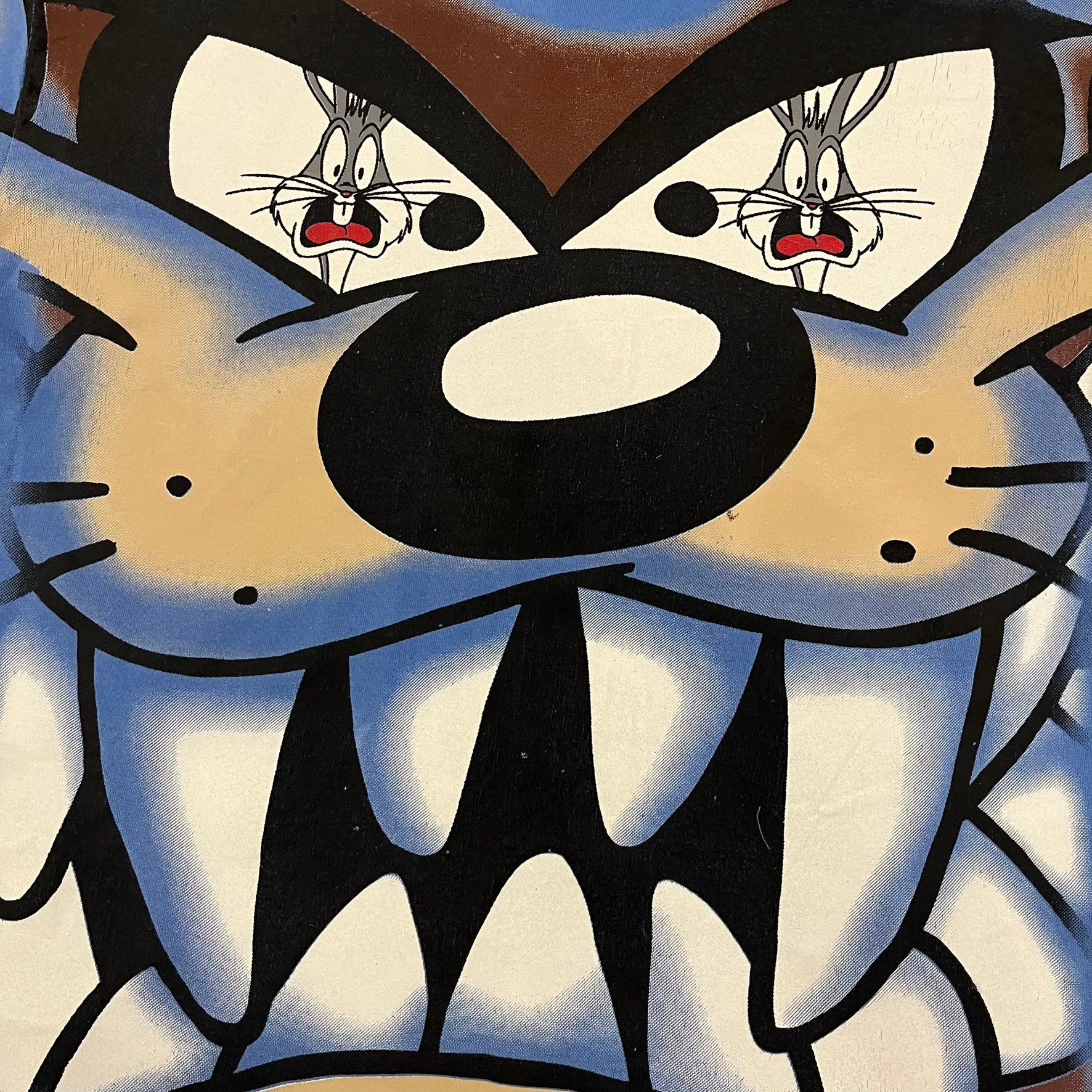 Looney Tunes “Taz & Bugs Bunny” 1997 Freeze Tee featuring a blue base with an all-over front print. The graphic shows Taz with an angry expression and Bugs Bunny reflected in his eyes, with 1997 Warner Bros. Freeze licensing printed below. Made in the USA from 100% cotton.