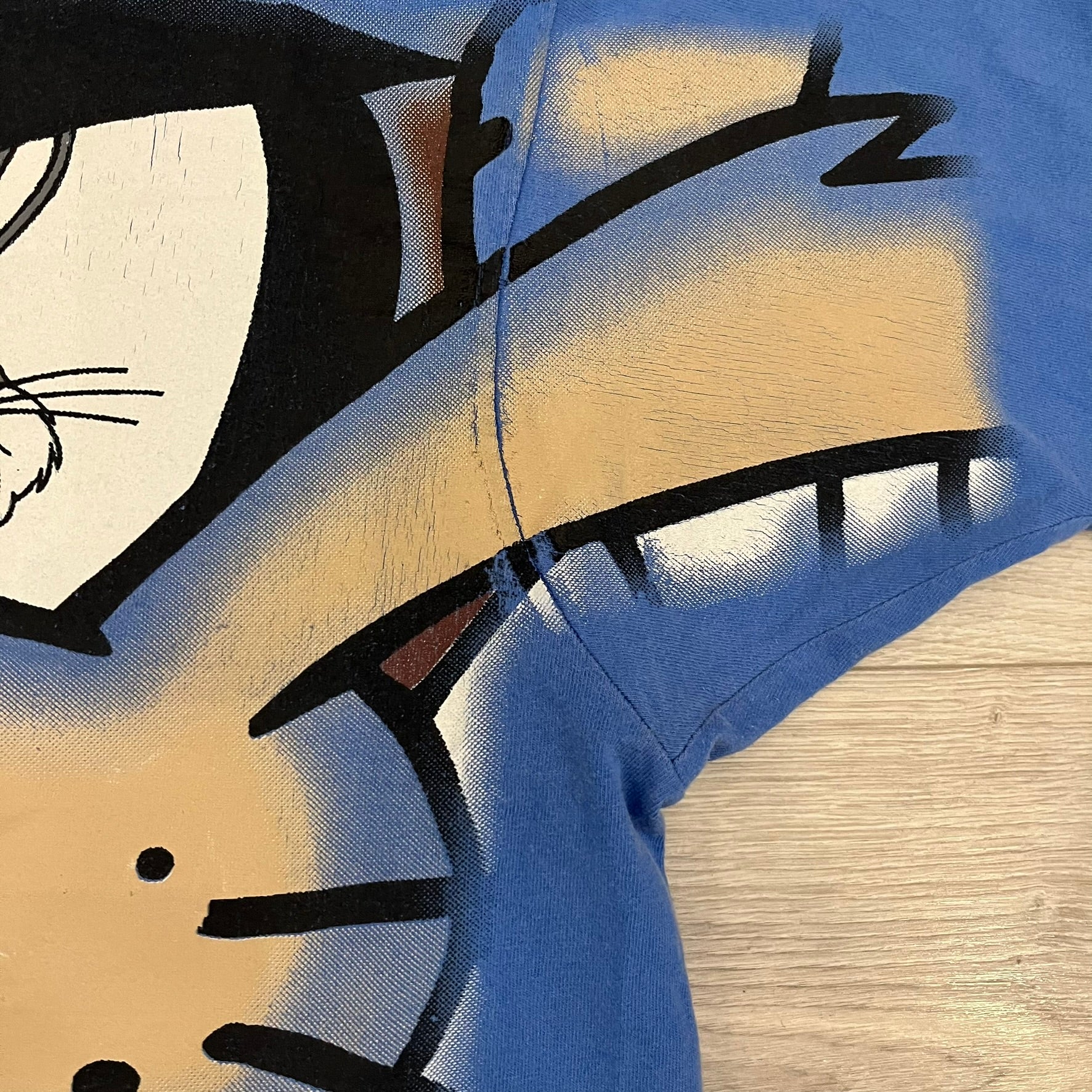 Looney Tunes “Taz & Bugs Bunny” 1997 Freeze Tee featuring a blue base with an all-over front print. The graphic shows Taz with an angry expression and Bugs Bunny reflected in his eyes, with 1997 Warner Bros. Freeze licensing printed below. Made in the USA from 100% cotton.