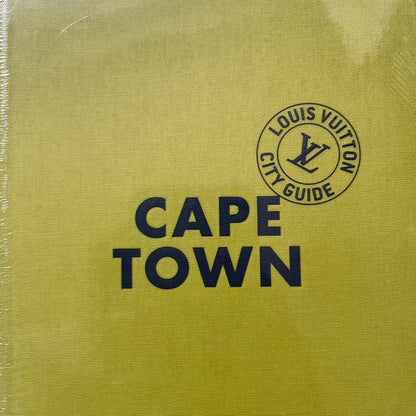 Louis Vuitton “Cape Town” City Guide is an English-language travel book with cloth binding, featuring contributions from writers Paul Duncan and Pnina Fenster. The guide includes a special guest contribution from Justin Fox, with exclusive photography by Grégoire Eloy. It covers Cape Town’s hotels, restaurants, cultural landmarks, and creative hubs, offering curated insights into the city’s art, design, gastronomy, and culture.