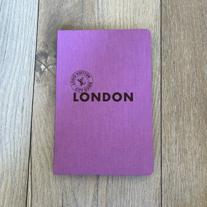 Louis Vuitton London City Guide is an English-language travel guide with a cloth-bound hardcover. It includes recommendations for hotels, restaurants, museums, shopping, and cultural locations across London. The edition features guest contributions by Richard Deverell, writing by Richard Cook, and exclusive photography by Grégoire Eloy.
