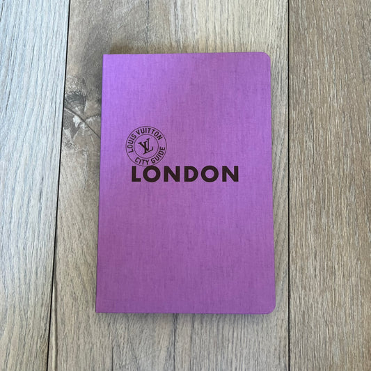 Louis Vuitton London City Guide is an English-language travel guide with a cloth-bound hardcover. It includes recommendations for hotels, restaurants, museums, shopping, and cultural locations across London. The edition features guest contributions by Richard Deverell, writing by Richard Cook, and exclusive photography by Grégoire Eloy.
