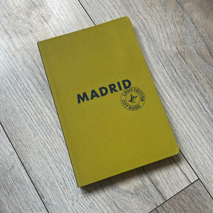 Louis Vuitton “Madrid” City Guide is a 320-page English-language travel book with cloth binding. It features contributions from writers Stephen Phelan, Ian Mount, Michael Stothard, and Joanna Wivell, with a special guest contribution from Sara Hurtado. Photography is provided by Mat Jacob of the Tendance Floue collective, offering curated insights into Madrid’s hotels, restaurants, cultural landmarks, and creative hubs